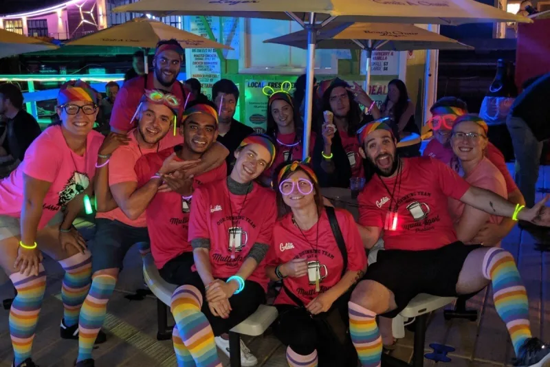 A CSSC team in matching pink shirts at a glow-themed social night