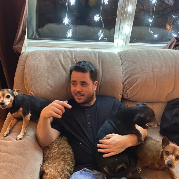 Jonny Toombs on a couch with his dogs