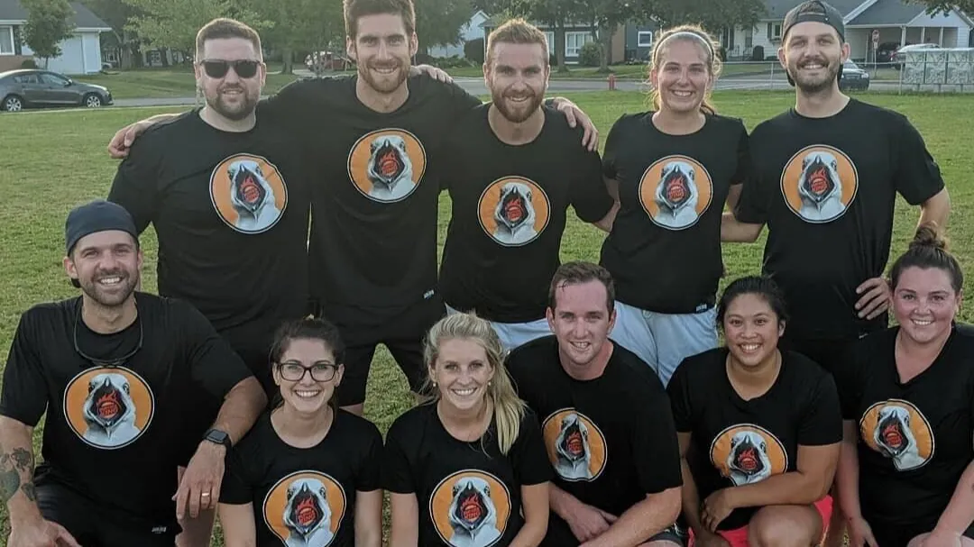 A CSSC team in matching black shirts on a grass field